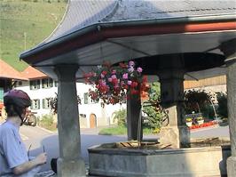 Olly next to the Lessoc Fountain, at Lessoc, 50.0 miles into the ride